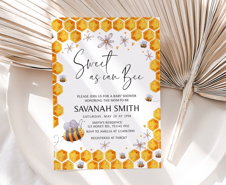 May include: A white baby shower invitation featuring a honeycomb pattern and a bee illustration. The text reads "Sweet as can Bee" and includes the name "Savannah Smith" and details for the event.