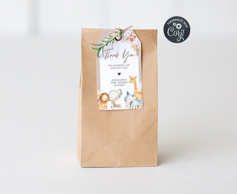 May include: A brown paper gift bag with a white tag attached. The tag has a thank you message, a giraffe, a lion, a rhino, and the text "Alexandra's Baby Shower 06.10.2023".