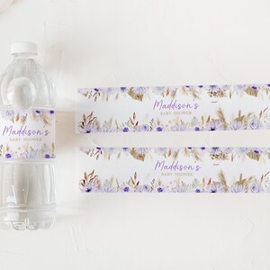 May include: Two water bottle labels with a floral design in shades of purple, brown, and white. The text on the labels reads "Maddison's Baby Shower".