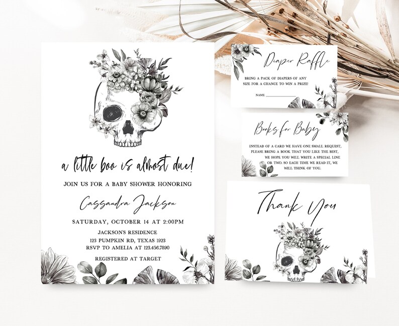 May include: A set of baby shower invitations and cards with a skull and floral design. The invitation reads "a little boo is almost due!" and includes details for the event. Additional cards include "Diaper Raffle," "Books for Baby," and a "Thank You" card.