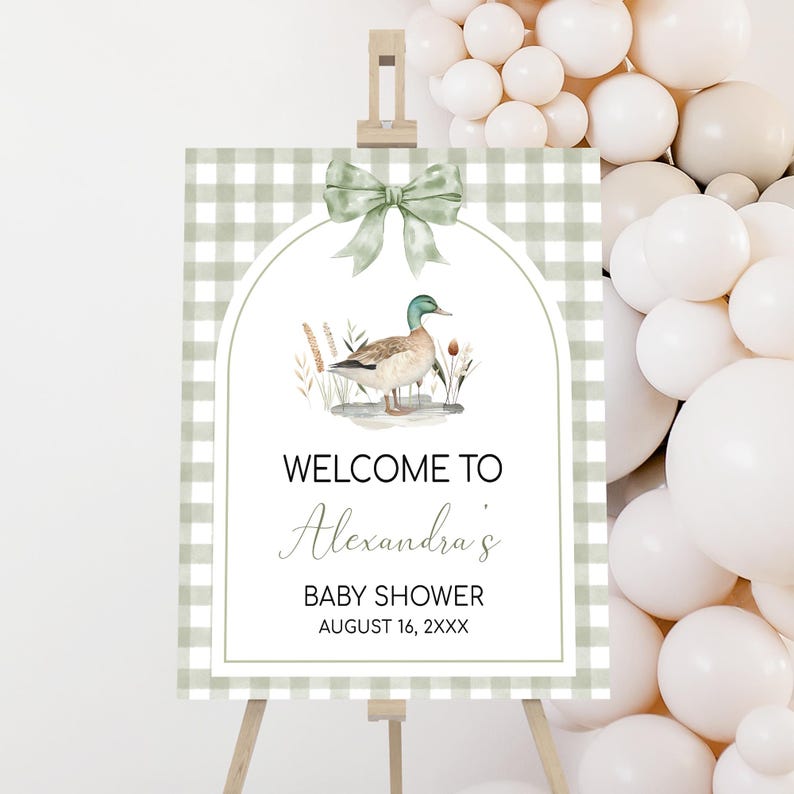 a welcome sign for a baby shower with balloons in the background