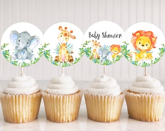May include: Four round cupcake toppers with a jungle animal theme. The toppers feature a giraffe, an elephant, a lion, and a group of animals including a giraffe, elephant, and lion. The toppers are printed on white cardstock and have a green leafy border. The text "Baby Shower" is printed on one of the toppers.