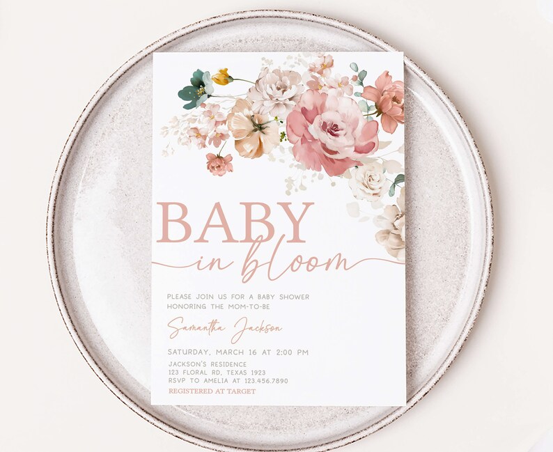 a baby in bloom card on a plate
