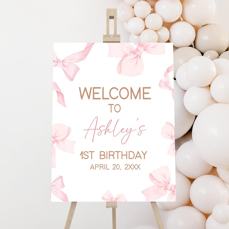 a welcome sign surrounded by white balloons