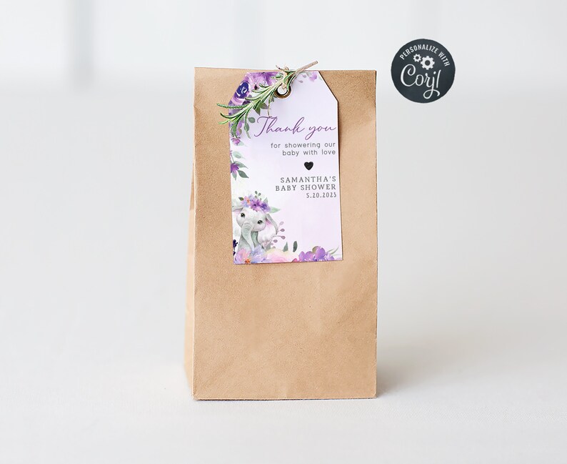 May include: A brown paper gift bag with a purple and white thank you tag. The tag features a watercolour illustration of a bunny with flowers and the text "Thank you for showering our baby with love Samantha's Baby Shower 5.10.2023".