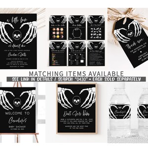 May include: A selection of black and white baby shower decorations with a spooky theme. The designs include invitations, gift tags, signs, and water bottle labels, all featuring skeleton hand and skull graphics. The text includes "a little bro is almost due" and "Welcome to Caroline's Baby Shower".