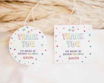 May include: Two colourful thank you tags with a rainbow design and the text "Thank You" and "For making my birthday colourful!" with the name "Gavin" on each tag.
