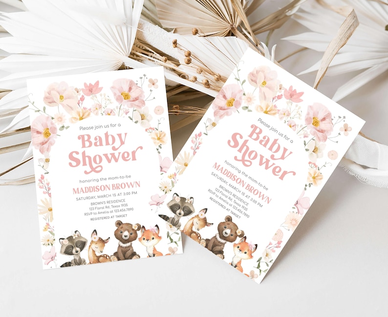 a couple of baby shower cards sitting on top of a table