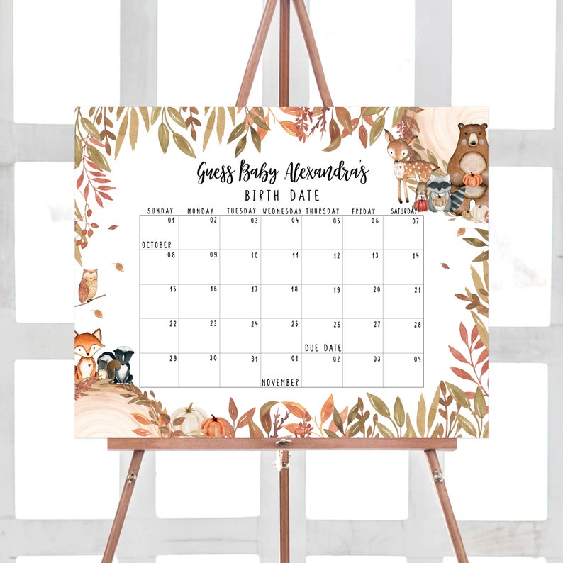 May include: A baby shower calendar on an easel, featuring a fall theme with woodland animals and autumn leaves. The calendar includes the text "Guess Baby Alexandra's Birth Date" and a calendar grid with the due date marked.