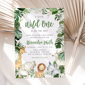 May include: A baby shower invitation with a jungle theme. The invitation features a green and white background with a variety of jungle animals, including a giraffe, elephant, lion, zebra, and rhinoceros. The text on the invitation reads "A Little Wild One is on the Way!" and includes the name "Alexandra Smith", the date and time of the shower, the location, and RSVP information.