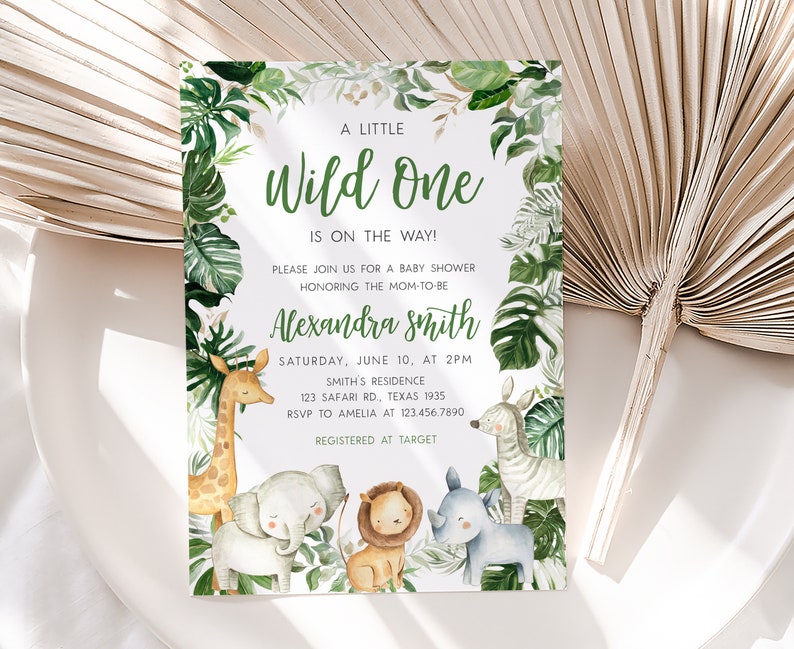 May include: A baby shower invitation with a jungle theme. The invitation features a green and white background with a variety of jungle animals, including a giraffe, elephant, lion, zebra, and rhinoceros. The text on the invitation reads "A Little Wild One is on the Way!" and includes the name "Alexandra Smith", the date and time of the shower, the location, and RSVP information.