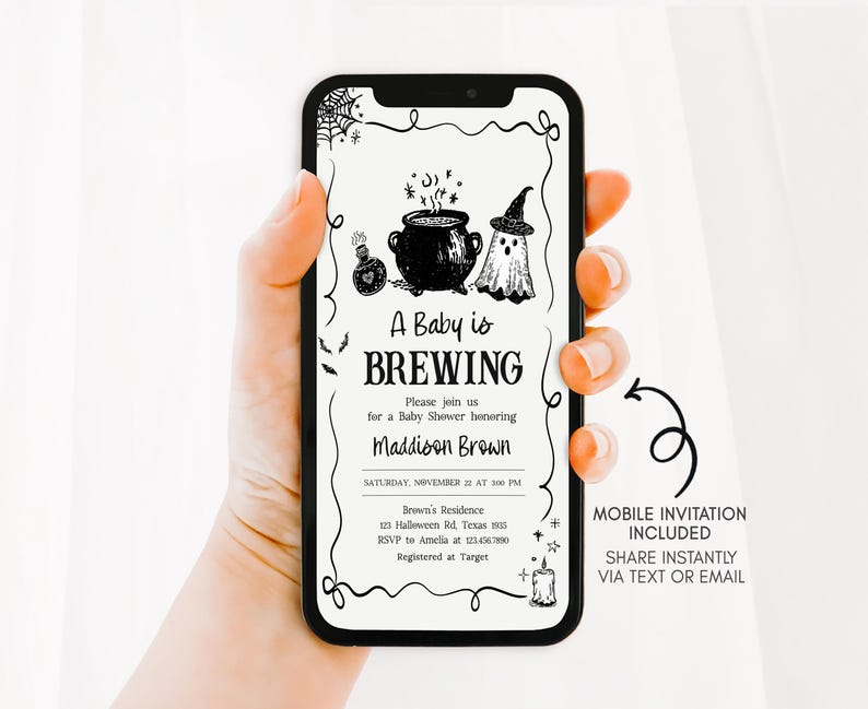 A hand holding a smartphone displaying an invitation for a baby shower.
