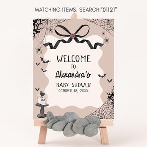 a welcome sign for a baby shower with rocks