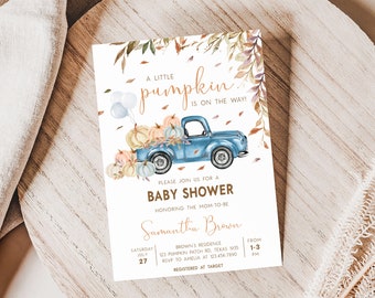 May include: Baby shower invitation featuring a blue vintage truck filled with pumpkins. The text reads "A Little Pumpkin is on the Way!" with details for the event, including the date, time, and location. The invitation has a watercolor style.