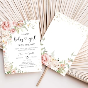 a white and pink wedding card with flowers on it