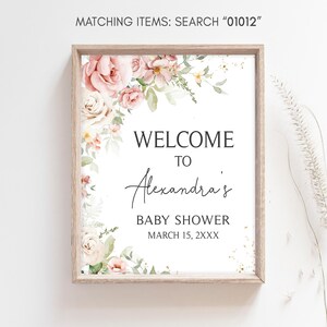 a baby shower sign hanging on a wall