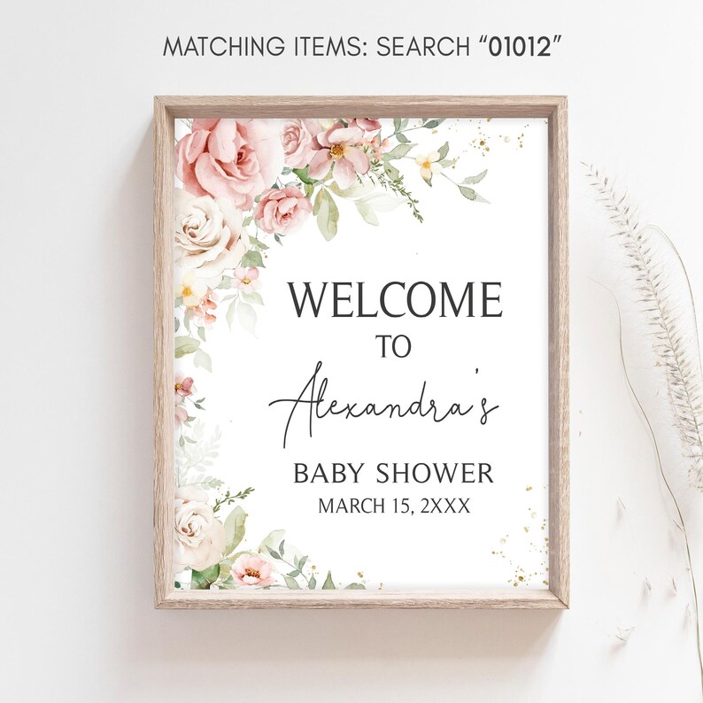 a baby shower sign hanging on a wall