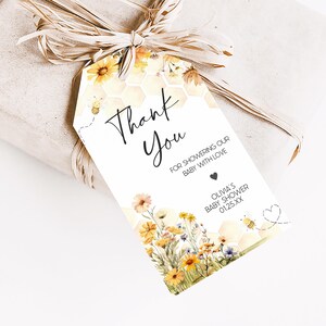 a gift wrapped in brown paper with a tag that says thank you