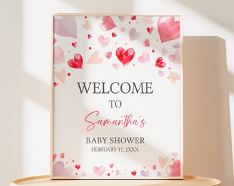 Könnte beinhalten: Ein weißes Schild mit einem Design aus rosa und roten Aquarellherzen. Der Text auf dem Schild lautet "Willkommen zu Samanthas Babyparty am 17. Februar XXXX".