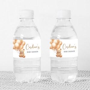 a bottle of water with a teddy bear on it