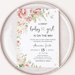 a baby girl is on the way card on a plate