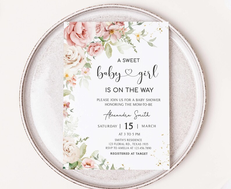 a baby girl is on the way card on a plate