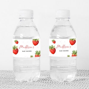 two bottles of water with strawberries on them