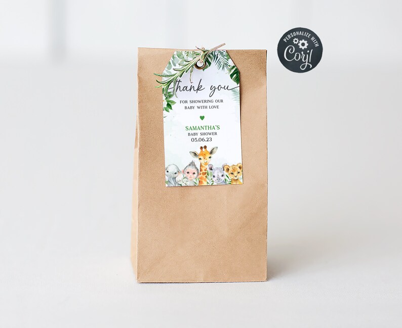 May include: A brown paper gift bag with a green and white thank you tag. The tag features a giraffe, a lion, a monkey, and a koala. The text on the tag reads "Thank you for showering our baby with love, Samantha's Baby Shower 05.06.23".