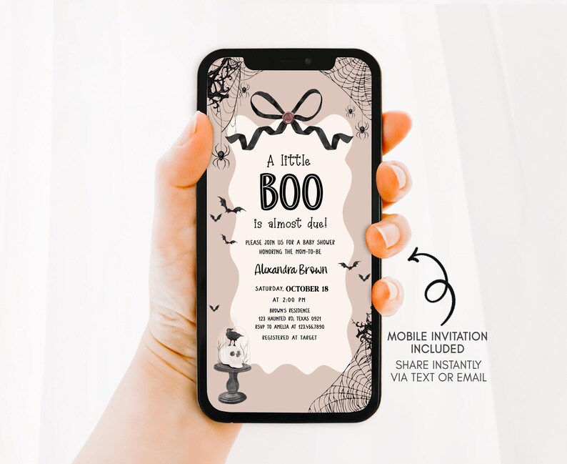 a woman holding up a phone case with a boo on it