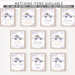 May include: A collection of ten rectangular signs featuring a light purple truck carrying a Christmas tree and woodland animals, decorated with purple floral accents and snowflakes. Each sign displays unique text for event stations and activities.