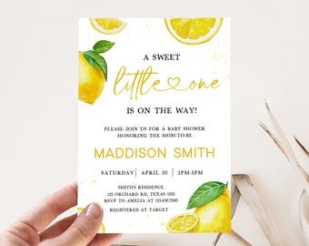 May include: A white baby shower invitation with a yellow lemon theme. The text reads "A Sweet Little One Is On The Way!" and includes the name "Maddison Smith".