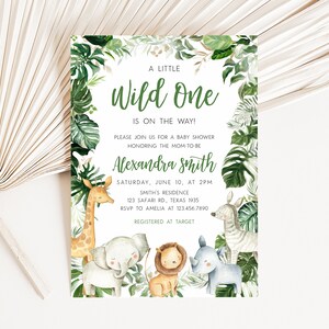 May include: A baby shower invitation with a jungle theme. The invitation features a green and white background with a variety of jungle animals, including a giraffe, elephant, lion, rhino, and zebra. The text on the invitation reads "A Little Wild One is on the Way!" and includes the name "Alexandra Smith", the date and time of the shower, the location, and the RSVP information. The invitation also includes the text "Registered at Target".