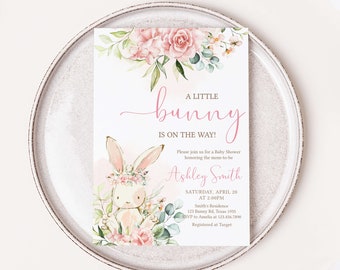 May include: A pink and green baby shower invitation with a watercolor illustration of a bunny wearing a flower crown. The text reads "A Little Bunny Is On The Way!" and includes the name "Ashley Smith" and the date and time of the shower.