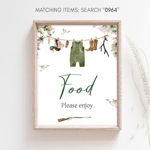 May include: A printable sign with a green and brown woodland theme. The sign says "Food Please enjoy" and has a picture of a baby onesie, a duck, a rifle, and boots hanging on a clothesline.