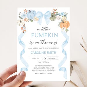 a person holding up a card with a pumpkin on it
