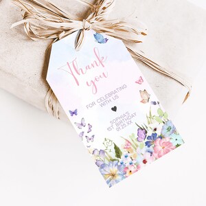 a gift wrapped in brown paper with a tag on it