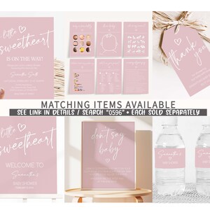May include: Pink and white baby shower decorations with the text "a little sweetheart is on the way!" and "Welcome to Samantha's Baby Shower". The decorations include a sign, a tag, and water bottle labels.