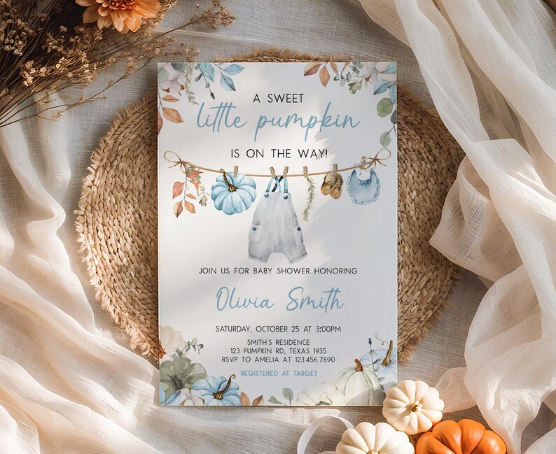 A baby shower invitation for a sweet little pumpkin baby shower, featuring a rustic and autumnal theme with illustrations of pumpkins, clothes, and flowers.