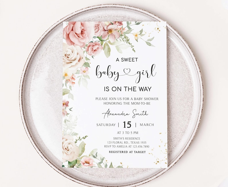 a baby girl is on the way card on a plate