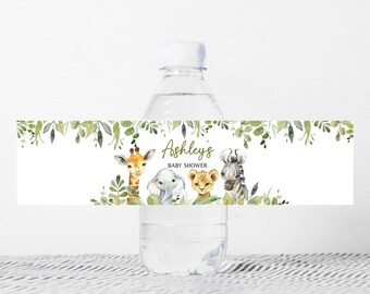 May include: Water bottle label with a green leafy border and a white background. The label features a giraffe, elephant, lion, and zebra with the text "Ashley's Baby Shower".