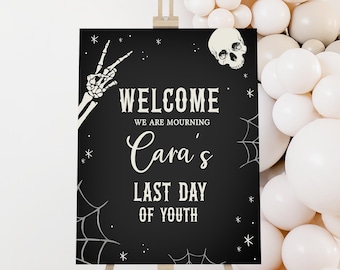 May include: Black and white welcome sign with a skeleton hand, skull, and spiderwebs. The sign reads "Welcome, We are mourning Cara's Last Day of Youth."