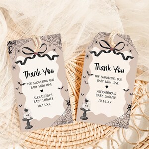 two thank you cards sitting on top of a wicker basket