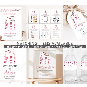 May include: A pink and white baby shower invitation with a mobile of hearts. The invitation says "A Little Sweetheart is on the way!" and includes the name Ashley Brown and the date February 14, 20XX. The invitation also includes the text "Welcome to Ashley's Baby Shower".