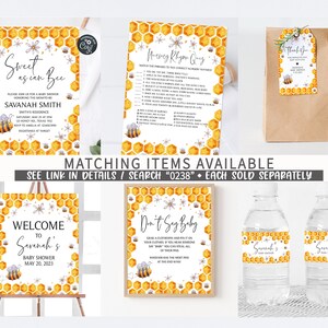 May include: A set of printable baby shower decorations with a bee and honeycomb theme. The set includes a welcome sign, a don't say baby game, a water bottle label, a thank you tag, and a baby shower invitation. The decorations are yellow, white, and gray.