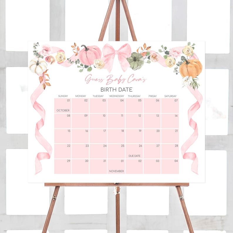 a pink floral baby shower calendar on a easel