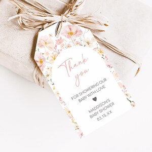 a gift wrapped in brown paper with a tag on it