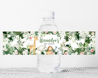 May include: Water bottle label with a jungle theme. The label features a giraffe, elephant, lion, and zebra surrounded by green leaves and pink flowers. The text on the label reads "Alexandra's Baby Shower".