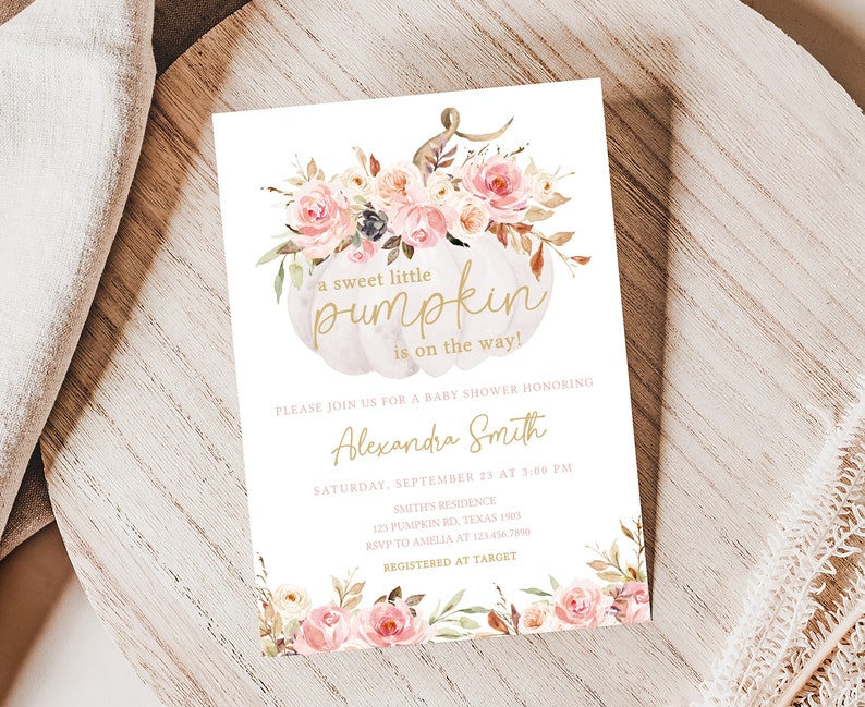 May include: Baby shower invitation with a white pumpkin design and floral accents. The text reads "a sweet little pumpkin is on the way!" and includes event details. The invitation is decorated with pink and peach roses.