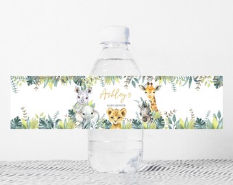 May include: Water bottle label with a jungle theme. The label features a giraffe, a lion, a rhino, and an elephant. The text on the label reads "Ashley's Baby Shower".