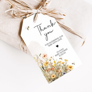 a gift wrapped in brown paper with a tag attached to it